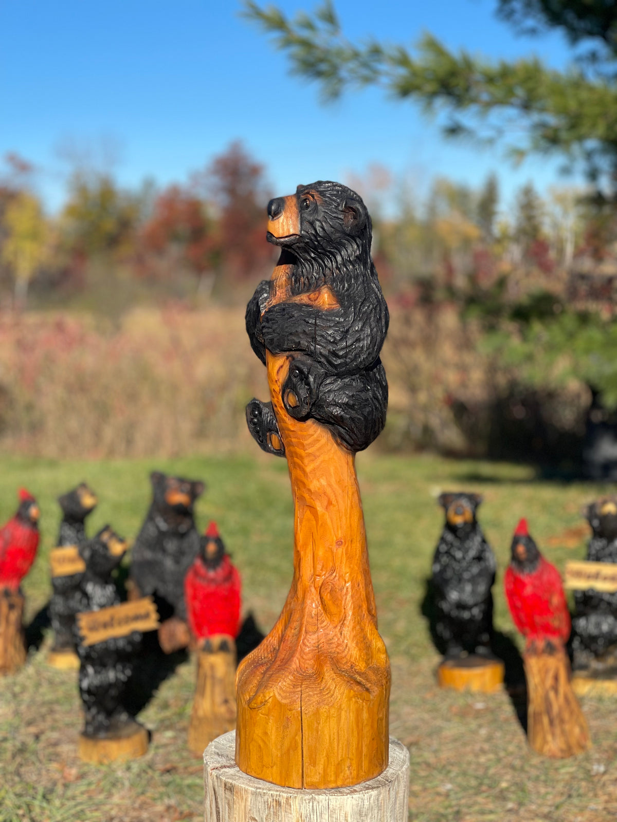 Bear cub in a tree chainsaw carving